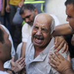 A grandfather of three Palestinian children cries outside a hospital morgue in Gaza City